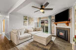 This cozy living room features a comfortable sectional sofa and a stylish ottoman, perfect for relaxing.