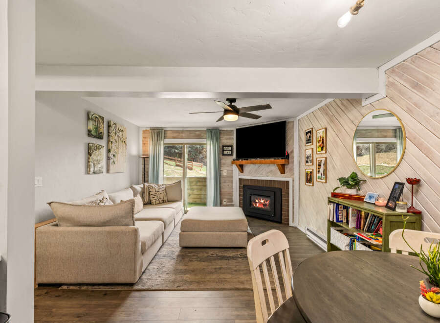 This cozy living space features a modern fireplace, perfect for those chilly evenings.