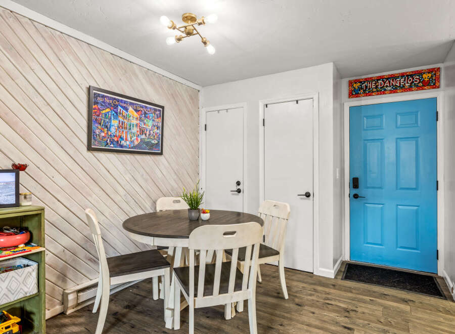 This charming dining area features a stylish round table and four matching chairs, perfect for intimate gatherings.