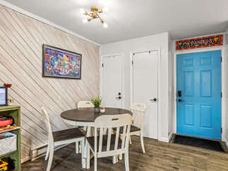 This charming dining area features a stylish round table and four matching chairs, perfect for intimate gatherings.