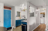 This charming property features a beautifully designed kitchen with modern blue cabinetry and sleek countertops.