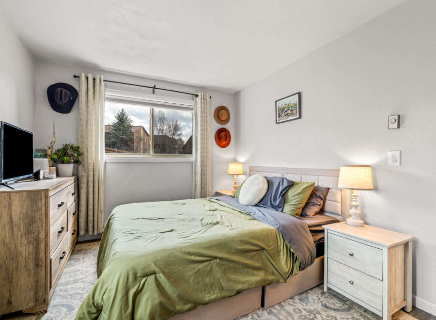 This cozy bedroom offers a serene retreat with its inviting ambiance and stylish decor.