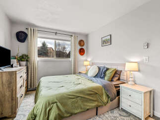 This cozy bedroom offers a serene retreat with its inviting ambiance and stylish decor.