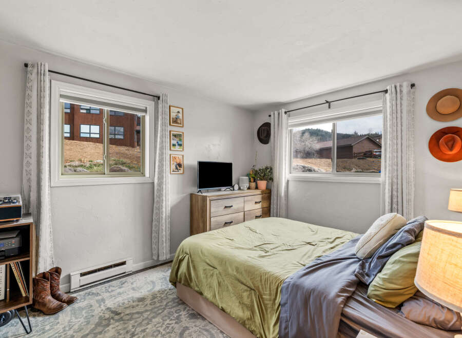 This cozy bedroom offers a tranquil retreat with its inviting ambiance and rustic charm.