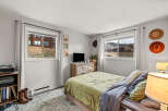 This cozy bedroom offers a tranquil retreat with its inviting ambiance and rustic charm.