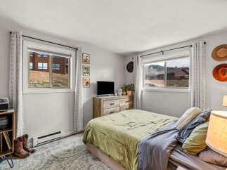 This cozy bedroom offers a tranquil retreat with its inviting ambiance and rustic charm.