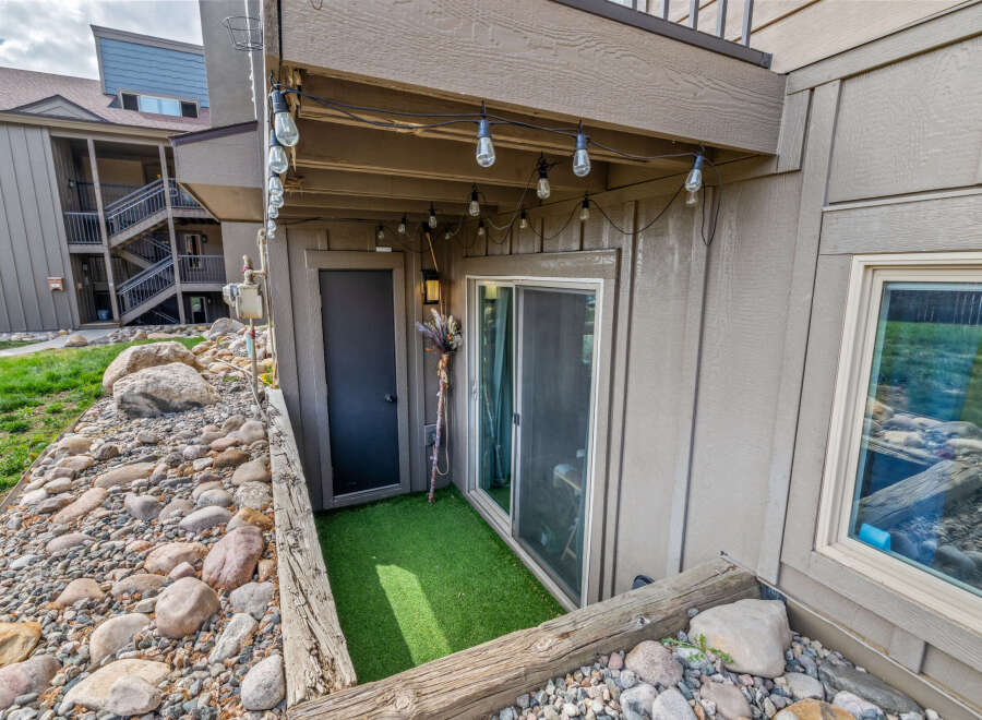 Discover the charm of this property, featuring a cozy outdoor space with a touch of greenery.