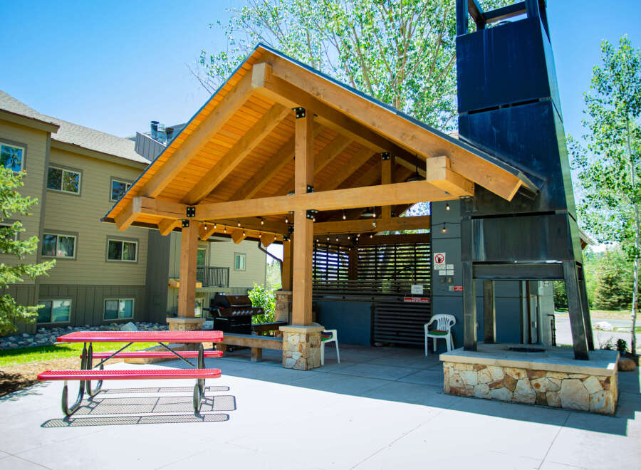 Enjoy outdoor living at its finest with this stunning property featuring a covered patio and a built-in barbecue area.