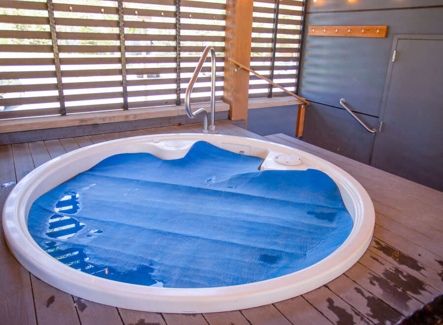 Relax and unwind in this luxurious outdoor hot tub, perfect for enjoying the serene surroundings.