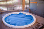 Relax and unwind in this luxurious outdoor hot tub, perfect for enjoying the serene surroundings.