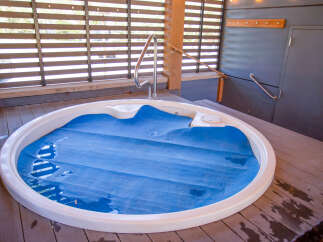 Relax and unwind in this luxurious outdoor hot tub, perfect for enjoying the serene surroundings.