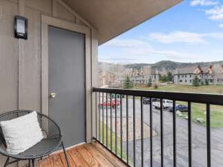Enjoy stunning views from this charming balcony! This property features a cozy seating area, perfect for relaxing and taking in the scenery.