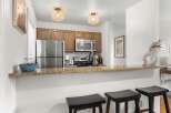 This stunning kitchen boasts modern appliances and stylish design, perfect for culinary enthusiasts.