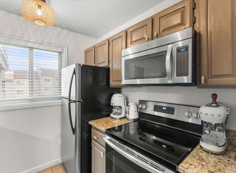 This stunning kitchen boasts modern appliances and ample counter space, perfect for culinary enthusiasts.