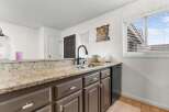 This kitchen boasts a stylish design with granite countertops and modern cabinetry.