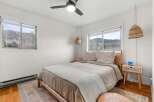 This cozy bedroom offers a serene retreat with its neutral color palette and natural light.