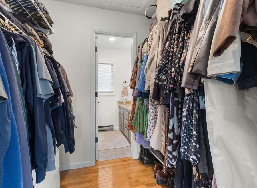 Step into this well-organized walk-in closet, offering ample storage space for your wardrobe.