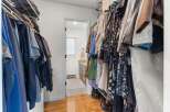 Step into this well-organized walk-in closet, offering ample storage space for your wardrobe.