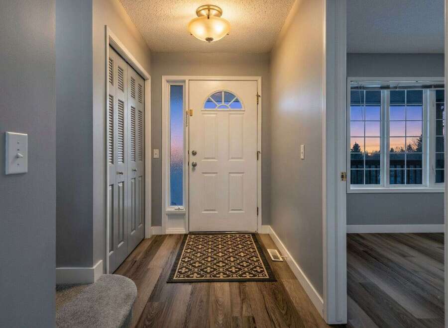 Step into this inviting entryway, featuring a stylish front door and a welcoming atmosphere.