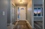 Step into this inviting entryway, featuring a stylish front door and a welcoming atmosphere.