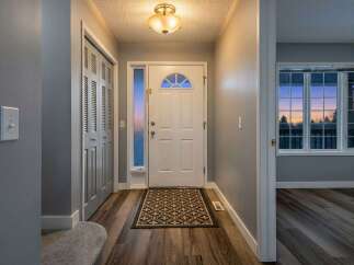 Step into this inviting entryway, featuring a stylish front door and a welcoming atmosphere.