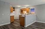 Step into this inviting kitchen, featuring warm wooden cabinetry and sleek countertops.
