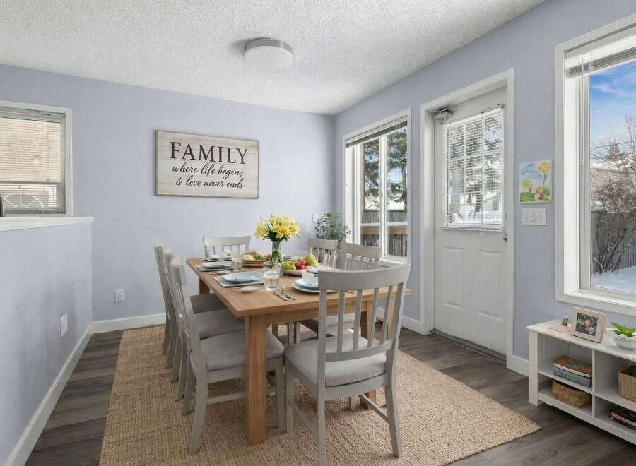 This inviting dining room features a stylish wooden table and comfortable chairs, perfect for family gatherings.