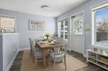 This inviting dining room features a stylish wooden table and comfortable chairs, perfect for family gatherings.