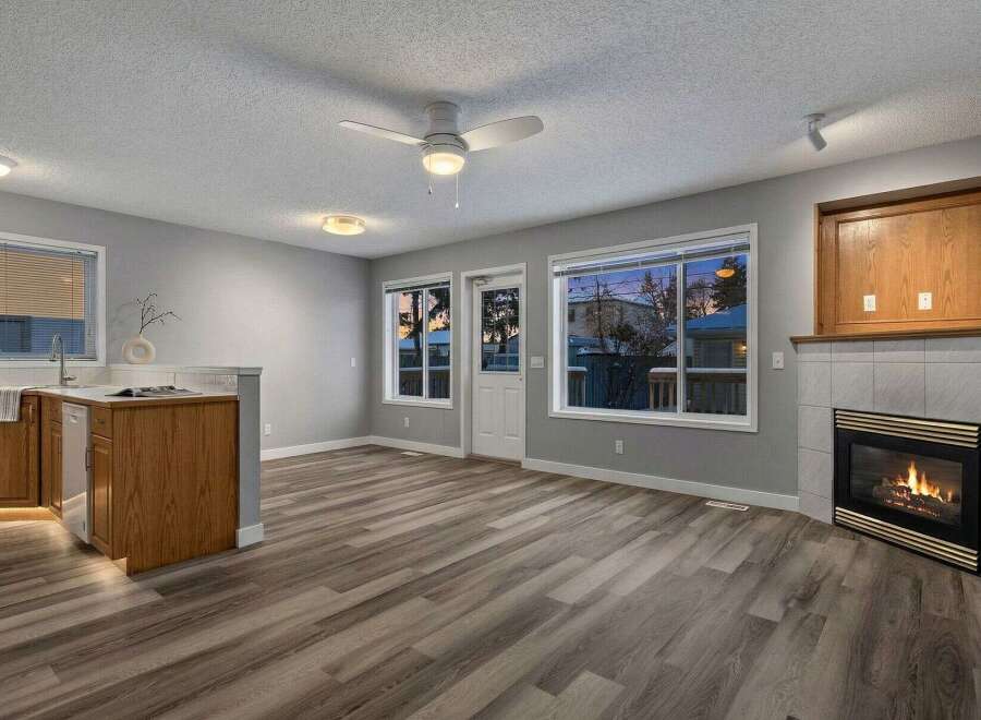 Step into this inviting living space, featuring a cozy fireplace and ample natural light.