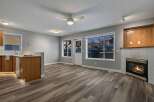 Step into this inviting living space, featuring a cozy fireplace and ample natural light.