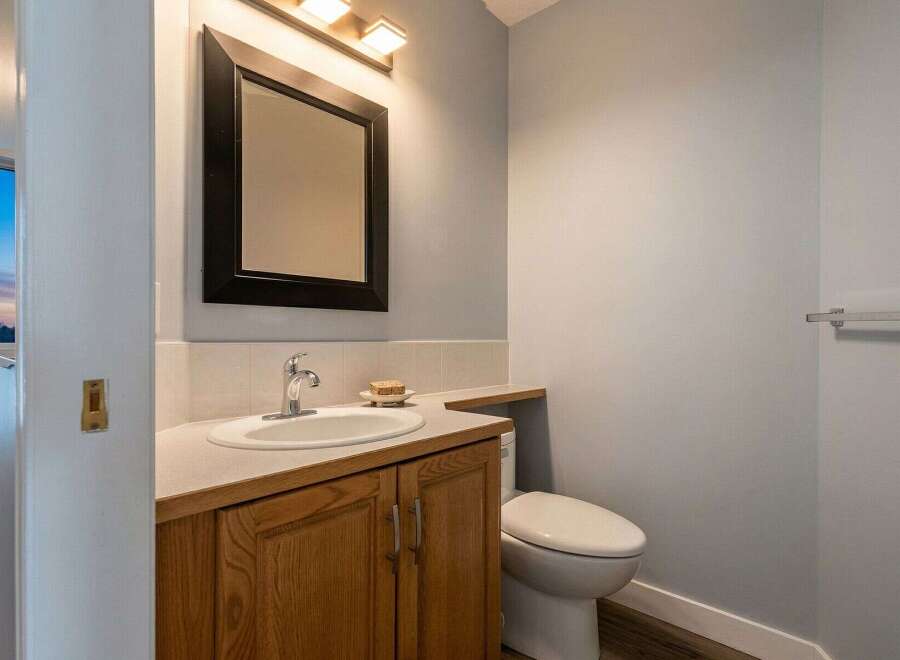 This stunning bathroom features a modern design with a sleek vanity and a stylish mirror.