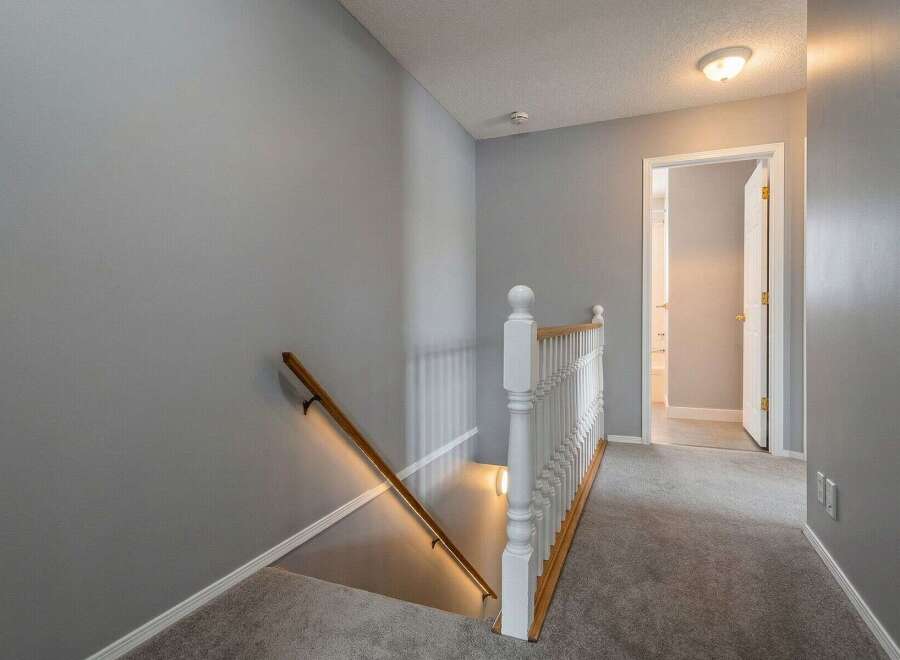 Step into this inviting home and discover a beautifully designed staircase leading to the upper level.