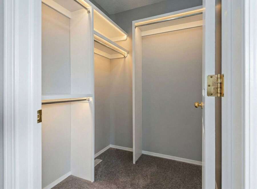 Step into luxury with this stunning walk-in closet! Featuring ample storage space and elegant lighting, this closet is perfect for organizing your wardrobe.