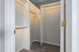 Step into luxury with this stunning walk-in closet! Featuring ample storage space and elegant lighting, this closet is perfect for organizing your wardrobe.