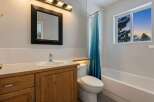 This inviting bathroom features a modern design with a sleek vanity and a stylish mirror.