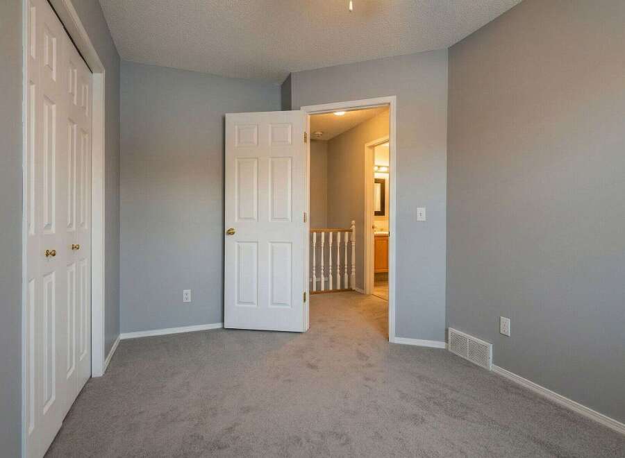 Step into this inviting bedroom, featuring a neutral color palette and ample natural light.