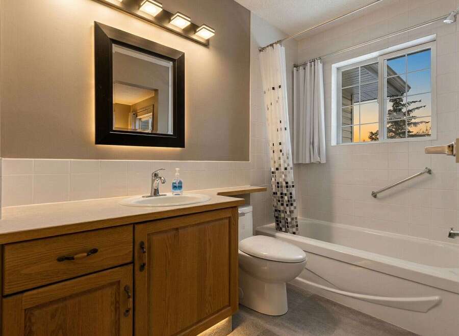 Step into this inviting bathroom, featuring a stylish vanity with ample storage and a sleek sink.