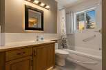 Step into this inviting bathroom, featuring a stylish vanity with ample storage and a sleek sink.