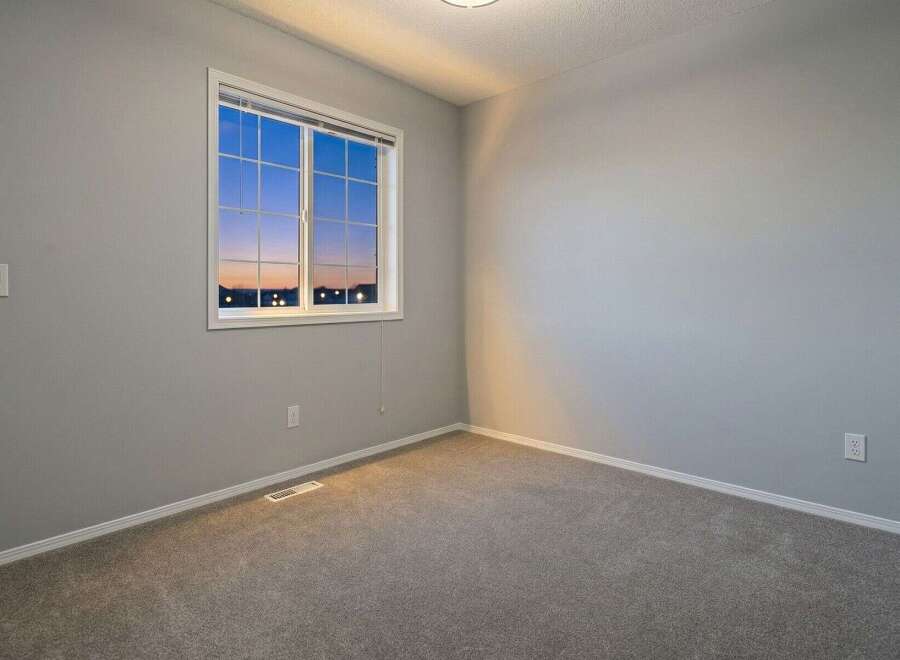 This inviting bedroom features a large window that allows natural light to flood the space, creating a bright and airy atmosphere.