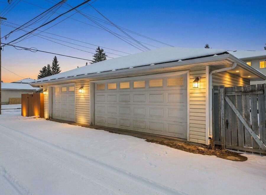 This charming property features a detached garage with two bays, perfect for parking and storage.