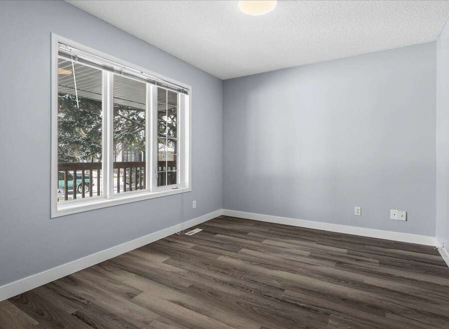 This inviting room features a large window that floods the space with natural light, offering picturesque views.
