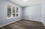 This inviting room features a large window that floods the space with natural light, offering picturesque views.