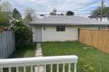 This charming property features a detached garage with a neutral color scheme and a well-maintained roof.