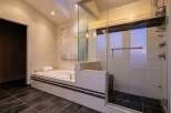 Step into luxury with this stunning bathroom featuring a sleek glass-enclosed shower and a relaxing soaking tub.