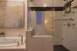 Indulge in luxury within this stunning bathroom, featuring a sleek glass-enclosed shower and a relaxing soaking tub.