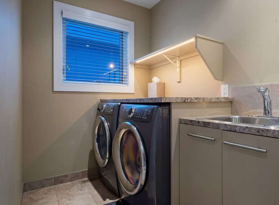 This stunning laundry room features modern appliances and stylish design.