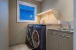 This stunning laundry room features modern appliances and stylish design.