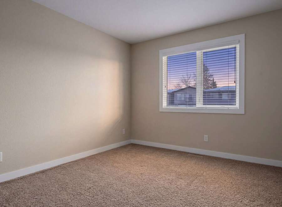 This inviting room features neutral walls and plush carpeting, creating a warm and welcoming atmosphere.