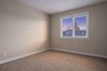 This inviting room features neutral walls and plush carpeting, creating a warm and welcoming atmosphere.