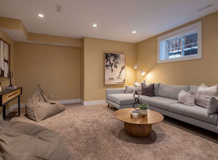 This inviting living space features a modern sectional sofa, perfect for relaxing and entertaining.